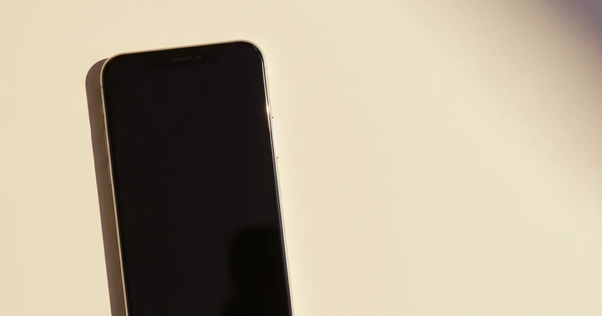 Hand holding an iPhone showing the eSIM install screen, with a soft purple gradient background